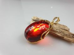 Deep Red amber pendant. Perfect stunning ruby red teardrop shape. Gold plated pendant (with stamping-hallmark). High quality. Teardrop shape elegant pendant. All natural parts, not plastic. Weight: 14.00 gr Pendant size: 5.5 x 2.6 cm MATCHING Earrings: https://www.etsy.com/uk/listing/912802337/ruby-red-amber-earrings-gold-plated?ref=shop_home_active_4&frs=1 This item was made of natural Baltic Amber. All the amber used in my jewelry is collected in my home country Lithuania. I sell only genu Solar System Jewelry, Communion Gifts Girl, Science Jewelry, Planet Necklace, Tube Necklace, Dainty Diamond Necklace, Custom Initial Necklace, Tiger Eye Jewelry, Family Tree Necklace