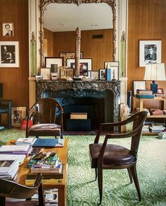 a living room filled with lots of furniture and a fire place in the middle of it