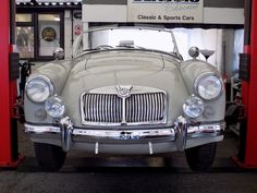 an old car is parked in the garage