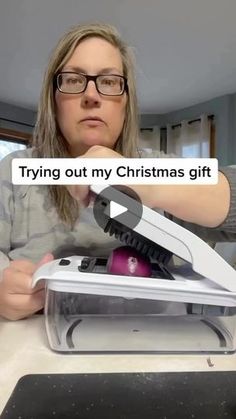 a woman sitting at a table with a laptop and mouse in front of her, text reads trying out my christmas gift