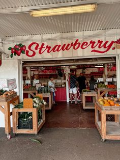 an open market with fruit and vegetables on display in front of the store's entrance