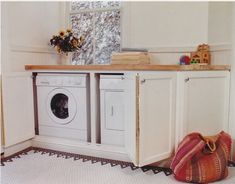 a washer and dryer sitting in a room next to each other on the floor