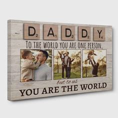 a wooden frame with the words daddy to the world you are one person and three pictures on it