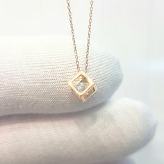 - Cube pendant necklace is made with high-quality 14K real solid gold. - The Inside of the cube, there is a diamond cut cubic zirconia stone and it is moving. - The dimensions of the cube is 0.5 X 0.5 X 0.5 cm. - This dainty, charm, tiny, delicate, cute and trendy pendant necklace has been artfully designed for timeless yet modern millennial fashion. - This 14K solid gold pendant comes with a beautiful matching free 14K real solid gold chain. - You receive the pendant in a beautiful and free gif Square Pendant Solitaire Necklace With Diamond Cut For Gift, Diamond Cut Solitaire Necklace With Square Pendant For Gifts, Square Diamond Cut Solitaire Necklace As Gift, Diamond Cut Solitaire Necklace With Square Pendant, Rose Gold Clavicle Chain Necklace For Anniversary, Cubic Zirconia Square Pendant Necklace For Gifting, Square Pendant Diamond Cut Necklace As Gift, Gift Diamond Necklace With Square Pendant, Diamond Cut Square Pendant Necklace