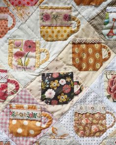 a patchwork quilt with coffee mugs on it