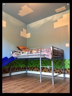 a bunk bed sitting in the middle of a room next to a slide and wooden floor