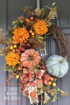 a wreath with pumpkins and gourds on it