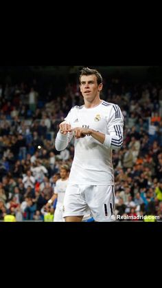 a soccer player holding a ball in front of a crowd