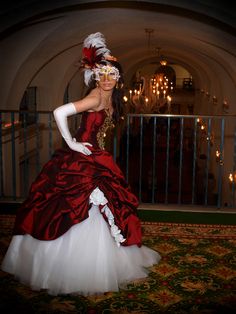 a woman in a red and white dress is posing for the camera