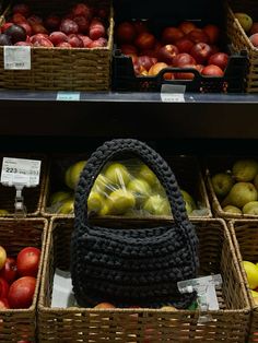 an assortment of fruits and vegetables in baskets on display at a grocery store with price tags