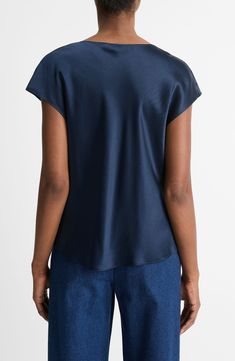 Timelessly chic, this silk popover blouse brings easy elegance to your look with a flattering draped cowl neck and dolman sleeves. 23" length (size Medium) Cowl neck Short sleeves 100% silk Dry clean or hand wash, line dry Imported Silk Top With Relaxed Fit For Work, Silk Top With Draped Sleeves For Work, Elegant Blue Viscose Tops, Fitted Silk Tops With Cuffed Sleeves, Chic Silk Top With Cowl Back, Blue Short Sleeve Silk Top, Blue Silk Short Sleeve Top, Blue Silk V-neck Blouse, Blue Moisture-wicking Short Sleeve Shirt