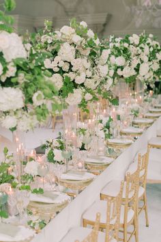 a long table with white flowers and candles