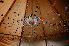 the inside of a large tent with lots of beads hanging from it