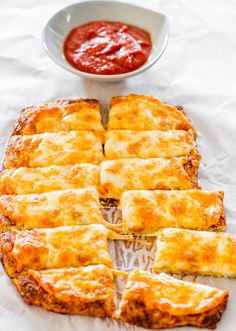 several pieces of pizza sitting on top of a pan covered in cheese and sauces