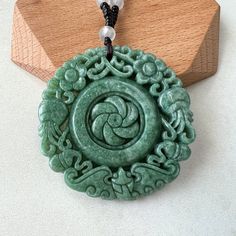 Circle Flower Swirl Necklace Stone Type: Natural Jadeite Jade (Grade A) Pendant Size: 2.15 x 2.15 x 0.26 in. Pendant Weight: ~65 to 80 g (combined) Translucency: Opaque Unique ID: GDTC-* NATURAL JADE: This is an exquisitely hand carved natural jadeite jade pendant. It is natural, un-dyed, and in its natural form. CARVING: The carving depicts a flower swirl in the middle with decorative flower patterns rotating out in the clockwise pattern. A very unique jade pendant. JADE COLOR: Green READY TO G Green Amulet Round Necklace, Green Round Amulet Necklace, Green Amulet Style Round Necklace, Green Pendant Flower Necklace As Gift, Green Flower Pendant Necklace With Large Pendant, Green Pendant Flower Necklace For Gift, Green Necklace With Large Flower Pendant, Green Carved Amulet Necklace, Jade Flower Necklace For Gift