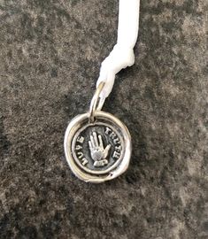 "Wax Seal Pendant/ TRUTH & LOVE in .999 fine silver. This measures just less than 1/2\". Each seal is hand crafted of fine silver (.999) Sterling silver is (.925). Each one is unique as the process is done by hand and not a press. The one you order will look as close to the picture as possible but no two are exactly alike. This is a process of many steps involving forming, drying, firing, hand polishing, and adding the final patina. If you want the silver to be shiny, I can leave off the ant Unique Hand Stamped Sterling Silver Jewelry, Symbolic Hand Stamped Sterling Silver Jewelry, Adjustable Hand Stamped Sterling Silver Jewelry, Hand Stamped Silver Pendant Jewelry, Personalized Silver Jewelry For Good Luck, Hand Stamped Spiritual Sterling Silver Jewelry, Spiritual Hand Stamped Sterling Silver Jewelry, Spiritual Stamped Silver Jewelry, Silver Hand-stamped Round Pendant Jewelry