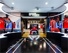 the inside of a store with basketball jerseys on display