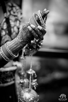 black and white photograph of a woman's hands holding an ornate bracelet