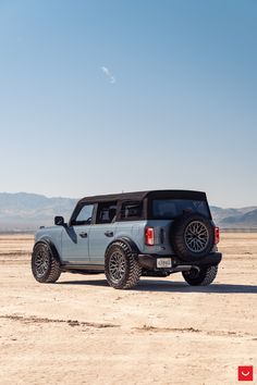 the truck is parked in the middle of the desert