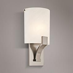 a wall light with a white shade on the side and a gray lamp behind it