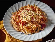 a white plate topped with pasta and sauce