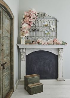 a room with a fireplace and flowers on the mantle