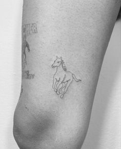 a small horse tattoo on the right side of the leg, with words written below it