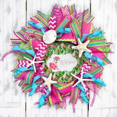 a colorful wreath with starfishs, seashells and ribbons