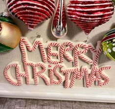 christmas ornaments and candy canes are arranged on a tray