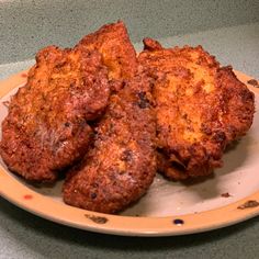 three fried meat patties are on a plate