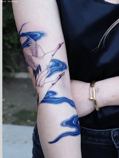 a woman with a bird tattoo on her arm