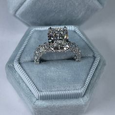 a cushion cut diamond ring in a velvet box