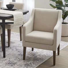 a dining room table with chairs and a rug