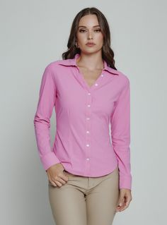 The Luxe Blouse features 4-Way Stretch fabrication that is both moisture-wicking and wrinkle free. This is a flattering semi-fitted blouse designed with mother of pearl buttons for a sophisticated look. Perfect for the office or a fancy dinner on the weekend. Details Model is 5'10" and wears a size small. Care: Machine wash cold on delicate cycle with similar colors. Do not use bleach or alcohol. Cool iron. Hang to dry. Composition: 78% Nylon | 22% Spandex Classic Stretch Blouse, Classic Stretch Solid Color Blouse, Classic Stretch Blouse With Button Closure, Classic Stretch Office Wear Blouse, Fitted Solid Color Blouse With Spread Collar, Pink Fitted Office Shirt, Pink Stretch Elegant Blouse, Pink Fitted Shirt For Office, Feminine Fitted Office Shirt