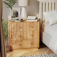 a bed room with a neatly made bed and a wooden dresser