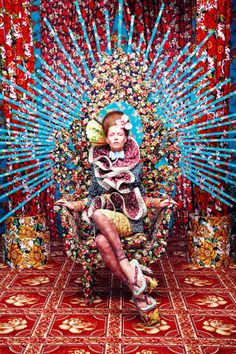 a woman sitting on top of a colorful chair