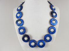 Statement mother of pearl  blue and white necklace,  blue and white shell Pearl Necklace Necklace, blue necklace, white  statement shell   Necklace is made from blue mother of pearl donut beads and white glass beads 10mm,  measures approx. 19" plus an additional 4" inches with silver extender. 1 Strands, light weight. Closure is a  lobster clasp with silver extender chain with bead dangle. My beautiful jewelry makes warm and personal gift for you, your family and friends, and all come in jewelry Blue Shell Beaded Necklaces With Round Beads, Elegant Blue Shell Necklace As A Gift, Elegant Blue Shell Necklace For Gift, Handmade Blue Shell Necklaces, Handmade Blue Pearl Necklace, Handmade Blue Shell Beaded Necklaces, Blue Shell Beaded Necklaces, Blue Handmade Shell Necklaces, Elegant Handmade Blue Shell Necklace