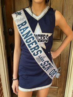 a girl in a cheer uniform is posing for the camera