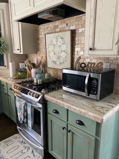 a kitchen with green cabinets and white appliances