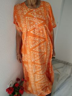 Orange cotton kaftan Printed Flowy Kaftan For Beach Cover-up, V-neck Batik Print Beach Dress, Casual Maxi-length Kaftan For Vacation, Traditional Boho Print Kimono For Beach, Traditional Summer Batik Print Kimono, Bohemian Oversized Tunic For Beach, Traditional Beach Kimono With Boho Print, Oversized Bohemian Tunic For Beach Cover-up, Beachwear Kaftan With Boho Print For Festivals