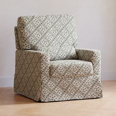 a living room chair sitting on top of a hard wood floor