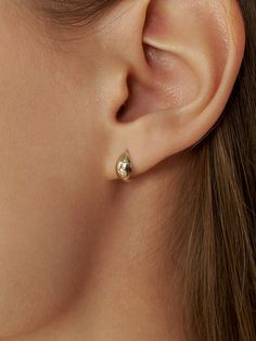 Editor's NotesLUNNE displays timeless fine jewelries that you can wear daily for long - Voluminous silhouette earrings- Accented with carved star shape - Tiny cubic stone at the center- Curved design that sits comfortably on the earMeasurements (in.)- Thickness 0.2 in.- Length 0.4 in.- Post thickness: Less than 0.1 in. (0.6mm)Composition & Care- 14K gold- Store in a ziplock bagDesigner- by LUNNE Fine Jewelry Single Oval Earring, Fine Jewelry Gold Oval Cabochon Earrings, 14k Gold-filled Oval Earrings, Celestial 14k Gold-filled Earrings, Gold Plated Star-shaped Single Earring, Silhouette Earring, Accessories Jewelry Earrings, Women Accessories Jewelry, Star Shape