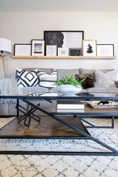 a living room filled with lots of furniture and pictures on the wall above it's coffee table