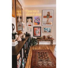 a living room filled with furniture and pictures on the wall