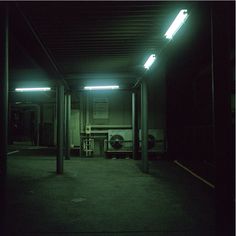 an empty parking garage at night with the lights on and no one in it yet