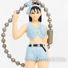 a figurine is holding a chain around it's neck and giving the peace sign