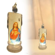 two candles that have pictures of jesus on them