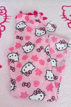 two pink hello kitty pajamas with bows on them