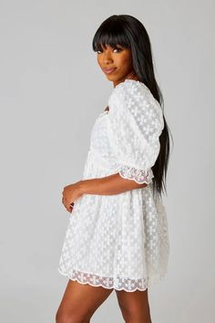 The Colby Dress features a drawstring in the front to adjust to your comfort, a slight puff sleeve, scalloped hem, and a smocked back to stretch around you. Fits true to size. *Available at our Rehoboth Beach location or Online Lace Puff Sleeve Dress For Brunch, Short Sleeve Puff Dress With Lace Trim For Daywear, Puff Sleeve Dress With Lace Trim For Daywear, Daywear Puff Sleeve Dress With Lace Trim, White Bishop Sleeve Dress For Daywear, Feminine White Puff Sleeve Dress With Gathered Neckline, White Puff Sleeve Dress With Gathered Neckline, Puff Sleeve Dress With Smocked Bodice For Daywear, White Puff Sleeve Dress With Gathered Neckline For Brunch