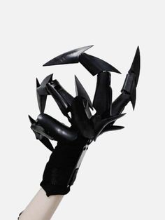 a black and white hand with several knives stuck in it